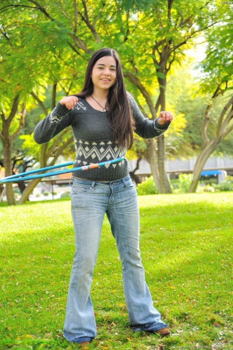 Chubby brunette takes off all her clothes in public while working a hula hoop