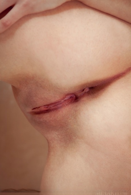 Beautiful teen girl showcases her hairless vagina in black stockings