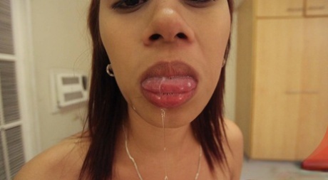 Petite Asian teen Lou pushes cum out her mouth during POV action