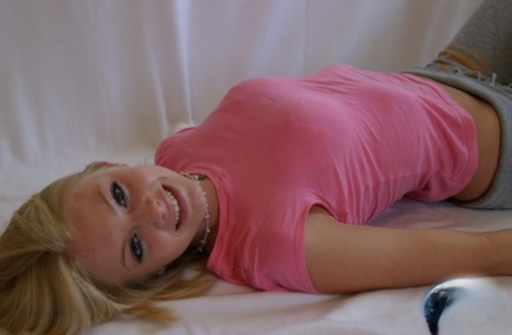 Cute teen girl Skye Model hangs out in a pink shirt and her yoga pants