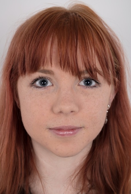 Cute redhead amateur uncovers her barely budding breasts as she gets naked