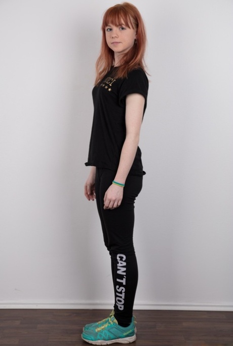 Cute redhead amateur uncovers her barely budding breasts as she gets naked