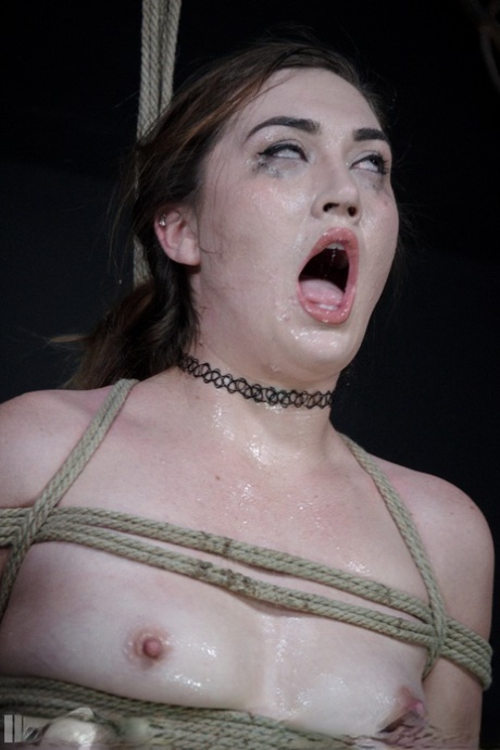 Restrained teen Kat Monroe drips drool from her chin during humiliating action