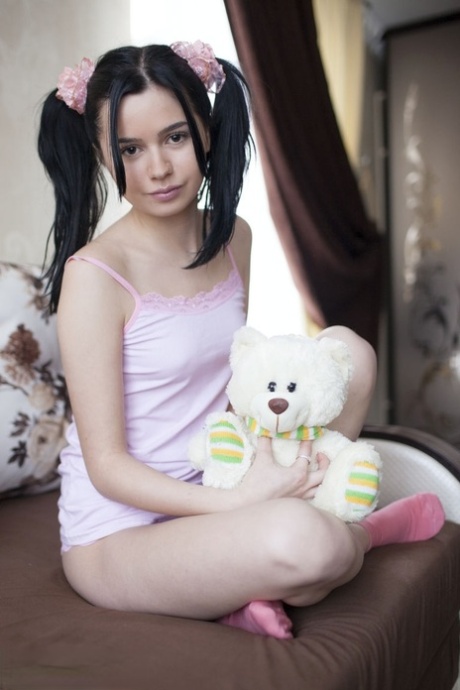 Cute teen Rozie shows her tight slit after putting down her plush toy