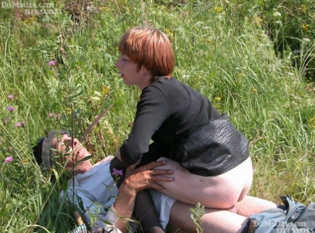Horny redhead lady finds an old hobo to fuck her horny pussy in a field