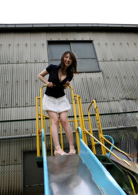 Japanese teen Takako Kitahara exposes upskirt panties on slide at playground