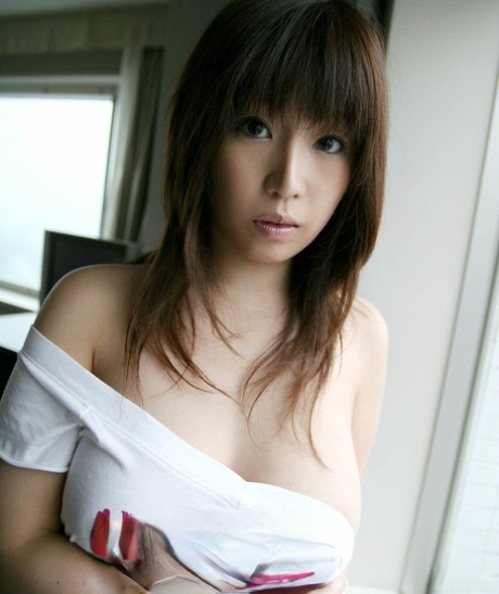 Young Japanese girl Yuka exposes her great tits in solo action
