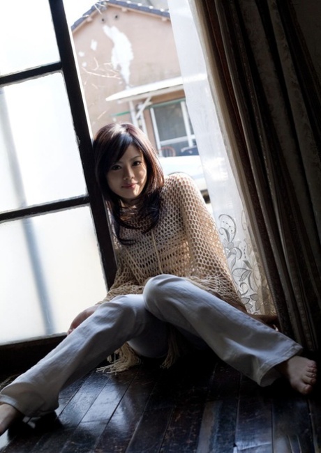 Beautiful Japanese girl China Yuki gets dressed after being naked on her bed