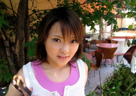 Young looking Japanese girl sinks her naked body into a tub of bathwater