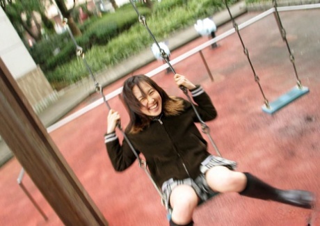 Japanese student Ami takes a bath after playing on a swing set