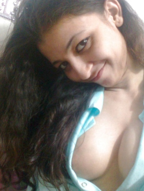 Indian solo girl holds her face firm while letting nipples free of lingerie