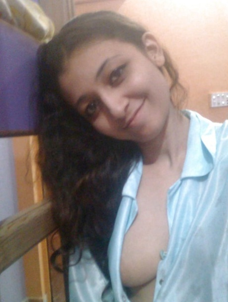 Indian solo girl holds her face firm while letting nipples free of lingerie
