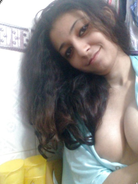 Indian solo girl holds her face firm while letting nipples free of lingerie