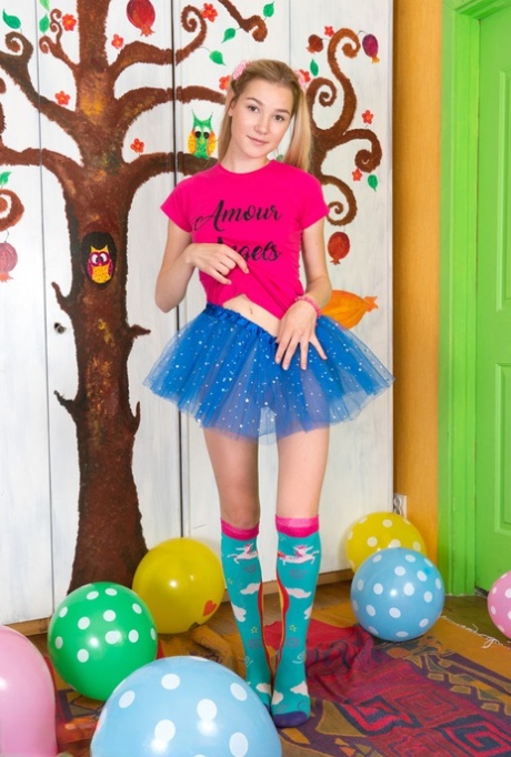 Young looking girl sports a no panty upskirt before getting nude amid balloons