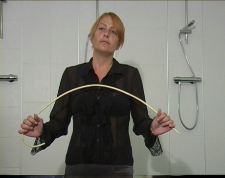 Blonde student is made to get naked before receiving a brutal caning