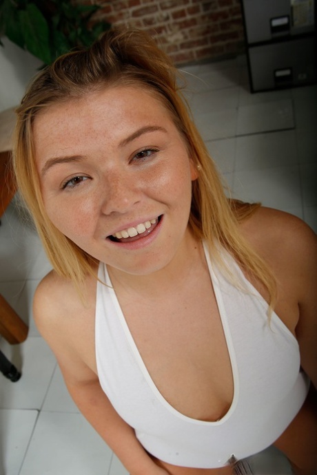 Chubby blonde strips naked before taking a long cock in her hands