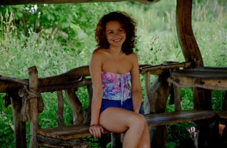 Young girl with curly red hair has sex with her guy on a rural deck