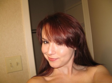 Natural redhead takes totally naked self shots in a mirror