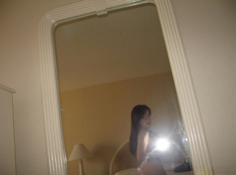 Natural redhead takes totally naked self shots in a mirror