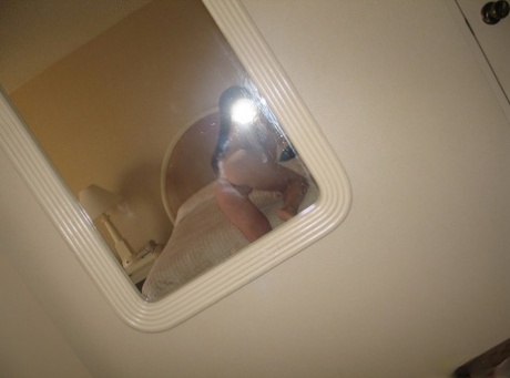 Natural redhead takes totally naked self shots in a mirror