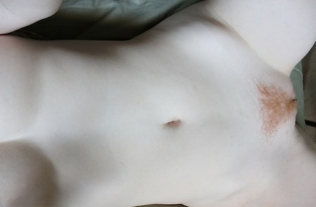 Pale redhead Lucy OHara takes selfies while fooling around on her bed on day
