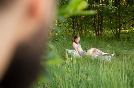 Young redhead Flicka Luchik wears her hair in pigtails during sex in a meadow