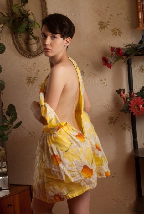 Young girl with short hair and perky tits gets naked in a confident manner