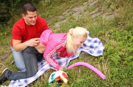Young blonde and her boyfriend fuck on a blanket out among nature