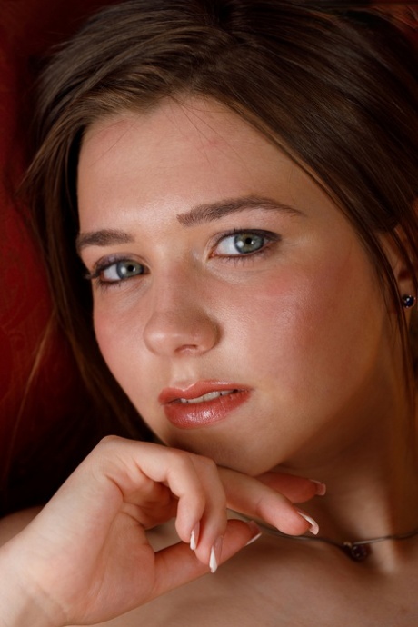 Young amateur Elvera gets completely naked on a red loveseat