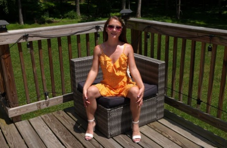 Young girl Mira Monroe masturbates with vegetables before peeing on a deck