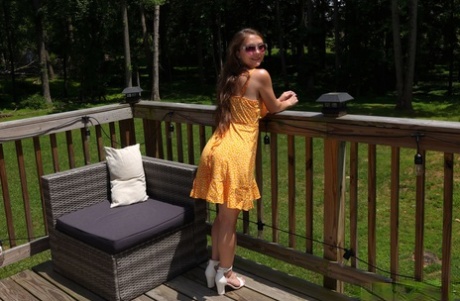 Young girl Mira Monroe masturbates with vegetables before peeing on a deck