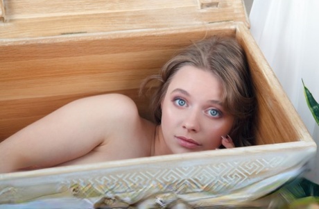 Gorgeous teen Siya emerges from a wooden trunk while totally naked