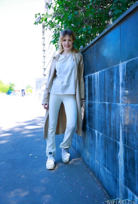 Charming teen Florens flashes in an overcoat before getting naked