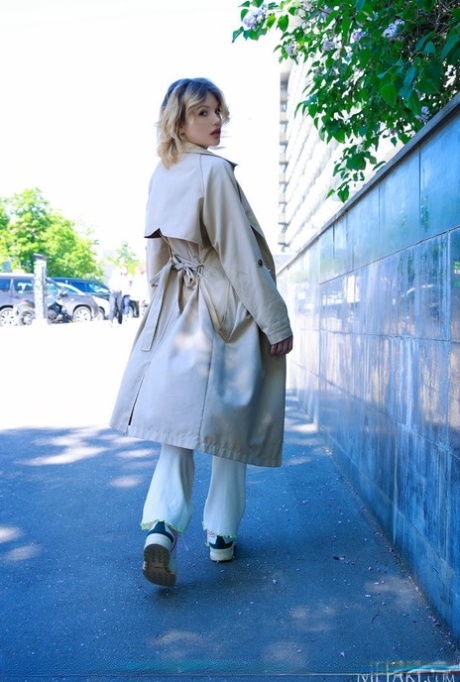 Charming teen Florens flashes in an overcoat before getting naked