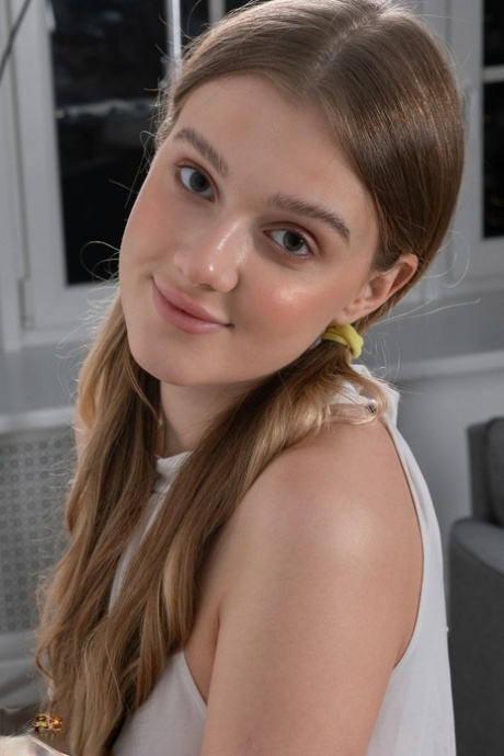 Nice teen Tiffany plays with her ponytails before getting totally naked