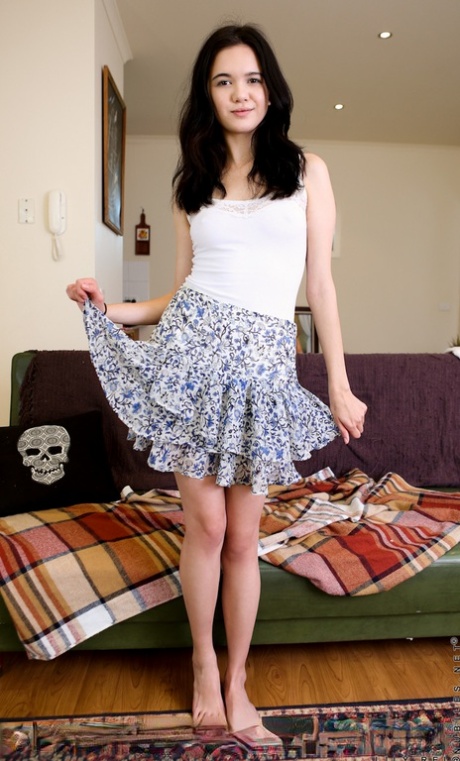 Darling little Lily Rei lifts up her short skirt and fingers her spread pussy