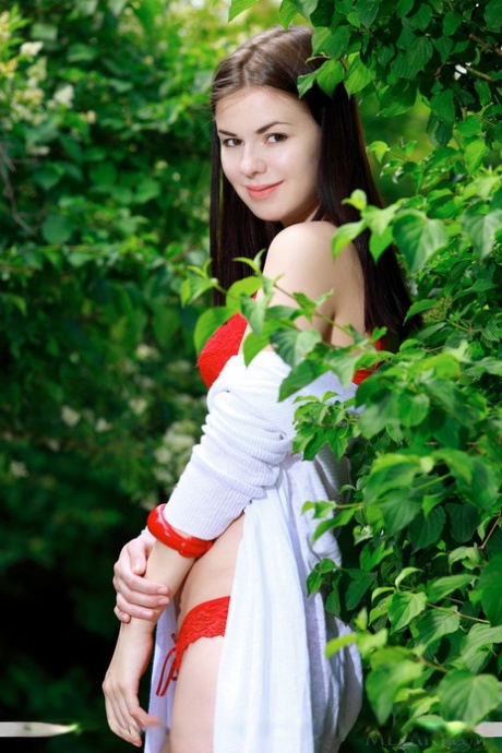 Brunette Euro babe Karolina Young frees big teen tits for outdoor glam pics