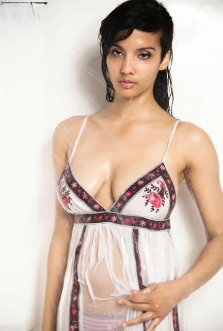 Indian solo girl takes off her wet dress to pose nude in the bathtub