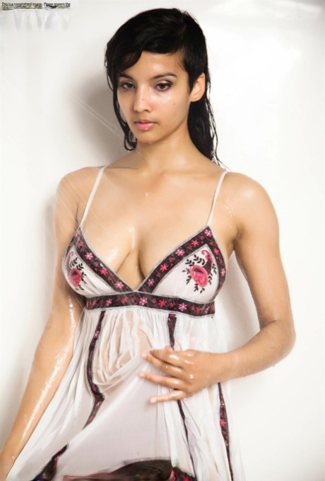 Indian solo girl takes off her wet dress to pose nude in the bathtub