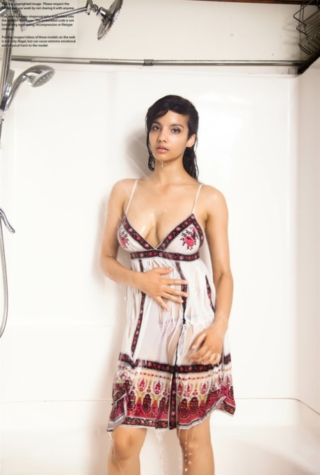 Indian solo girl takes off her wet dress to pose nude in the bathtub