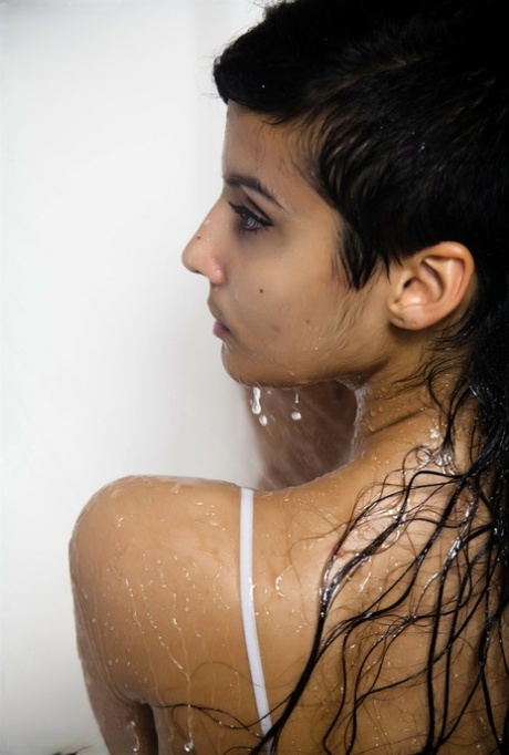 Indian solo girl takes off her wet dress to pose nude in the bathtub