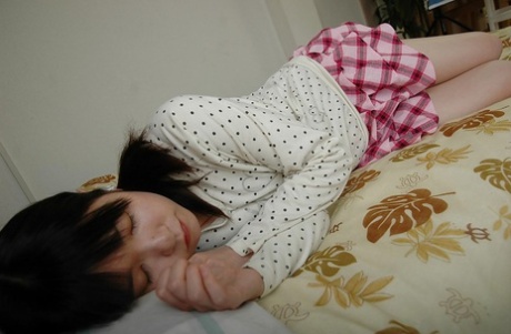 Asian teen in knee socks taking off her panties and exposing her shaved gash