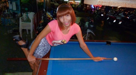 Skinny Asian tranny Jess posing outdoors in a skirt and high heels