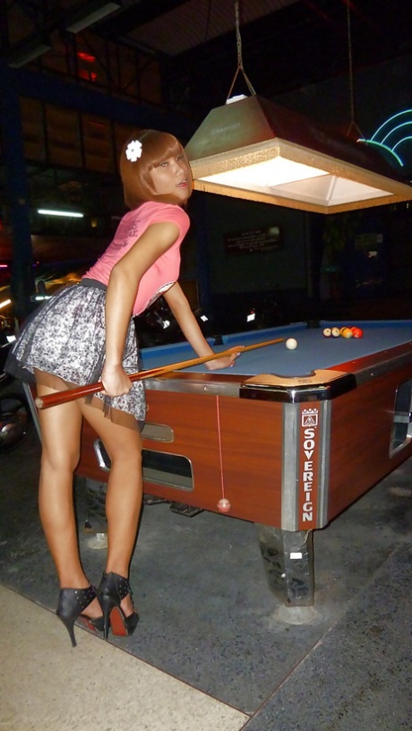Skinny Asian tranny Jess posing outdoors in a skirt and high heels