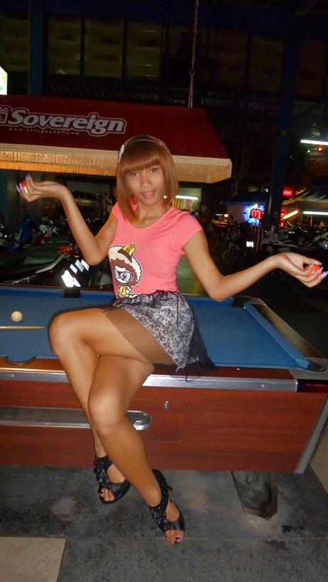 Skinny Asian tranny Jess posing outdoors in a skirt and high heels