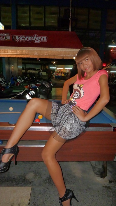 Skinny Asian tranny Jess posing outdoors in a skirt and high heels