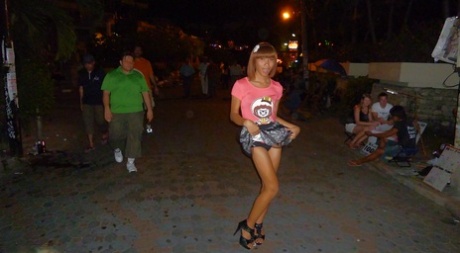 Skinny Asian tranny Jess posing outdoors in a skirt and high heels