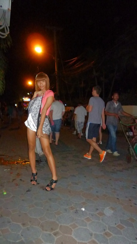 Skinny Asian tranny Jess posing outdoors in a skirt and high heels