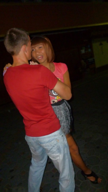 Skinny Asian tranny Jess posing outdoors in a skirt and high heels