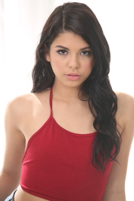 Adorable young Latina Gina Valentina strips off to offer her sexy petite ass